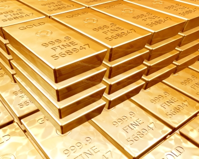 Stacks of pure gold bars on piles of bullion